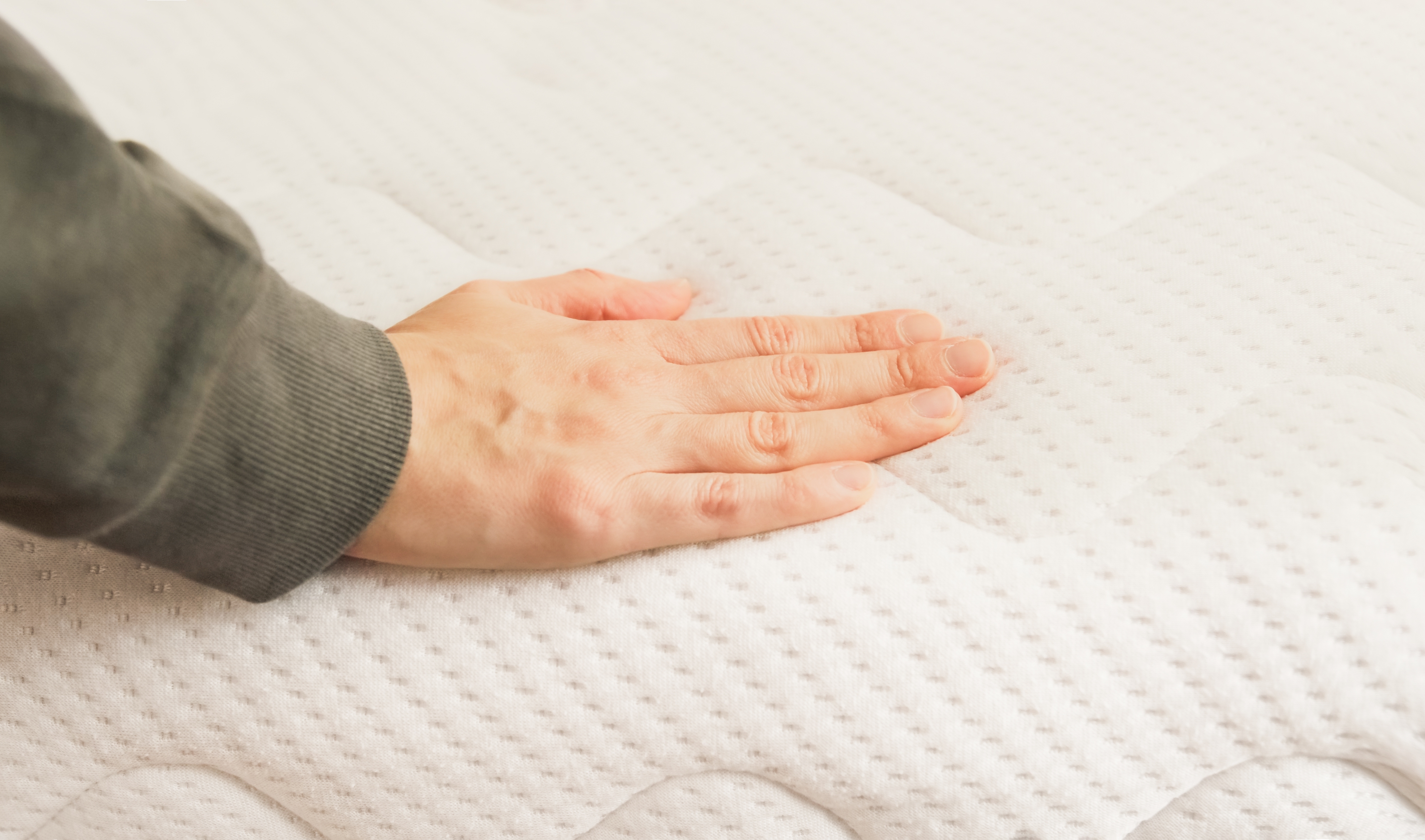 hand-touching-and-pressing-orthopedic-mattress-on-2022-11-16-17-18-30-utc.jpg