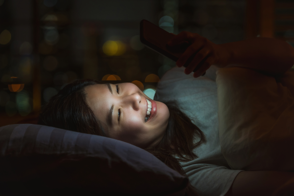 closeup-asian-woman-sleeping-and-using-smart-mobil-2022-12-16-03-31-08-utc-1030x687